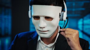 Businessman wearing white mask and headset, adjusting microphone in dark blue office. Concept of anonymous customer support, cybercrime, online security and identity concealment.